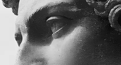 Classical stone bust in three-quarter profile, in warm black and white.